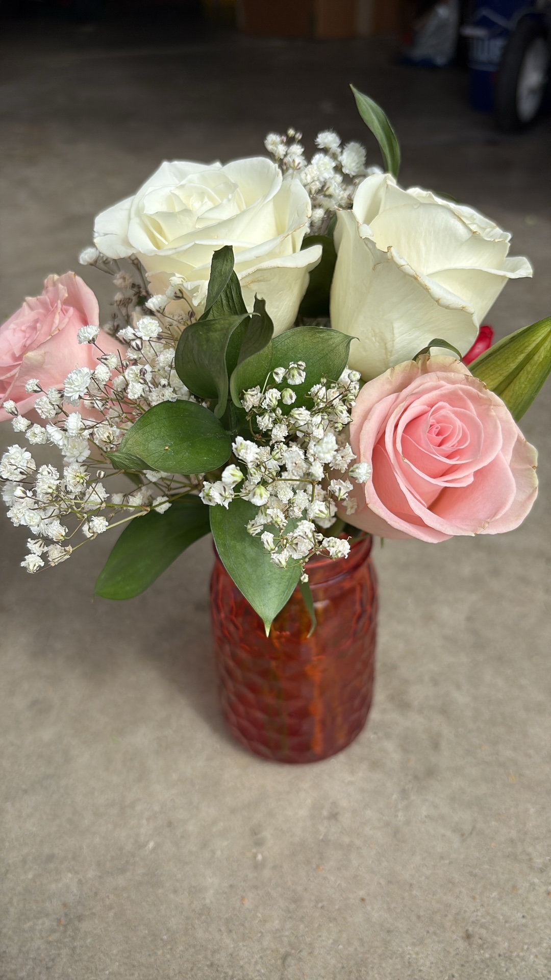 Hands wrapping a small bouquet in kraft paper