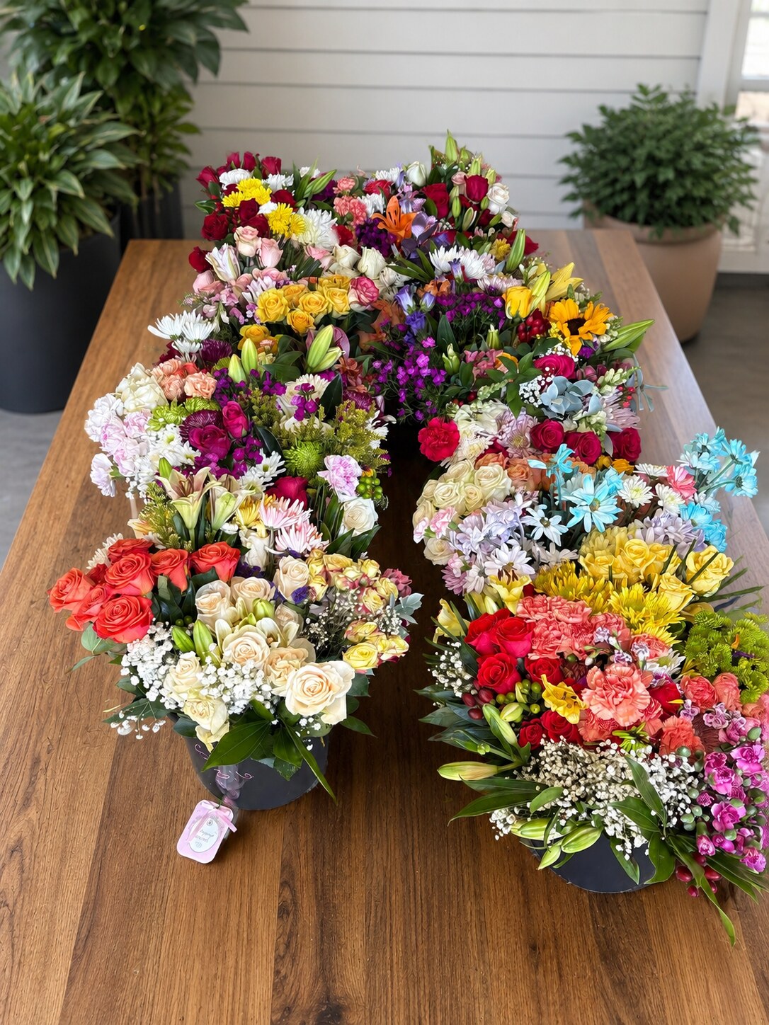 Overhead arrangement of rescued blush and cream garden flowers